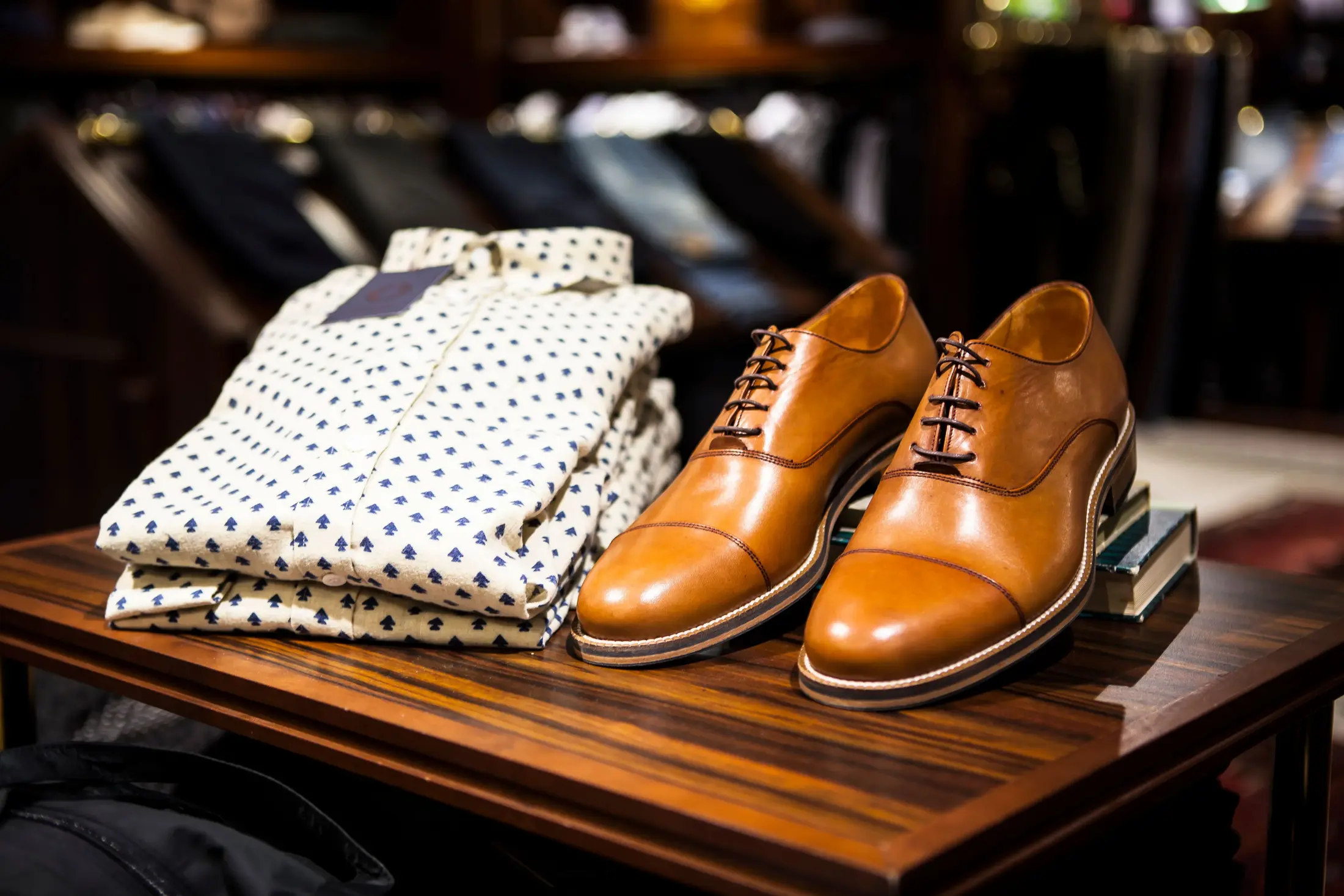 Neatly folded polka dot shirts and leather oxford shoes